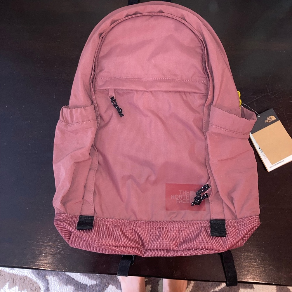 Pink/mauve body with yellow/chartreuse zippers Adjustable straps.